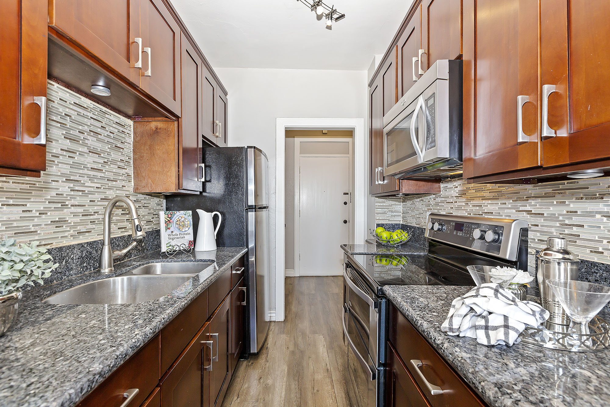 Galley-style kitchen with granite counter tops